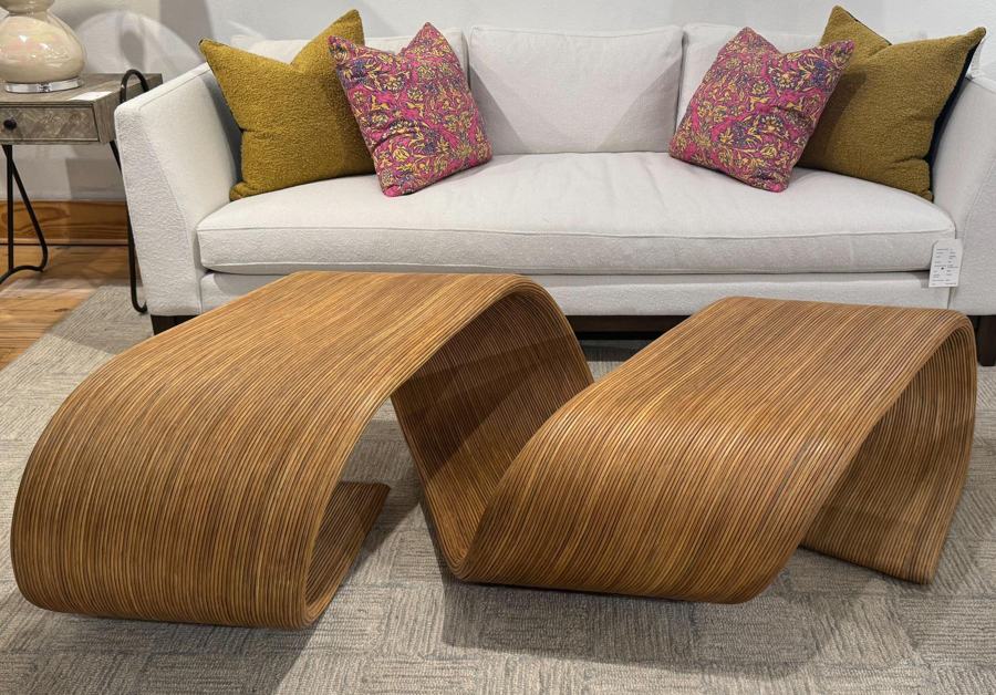 Sculptural woven-wood cocktail table in front of a white sofa